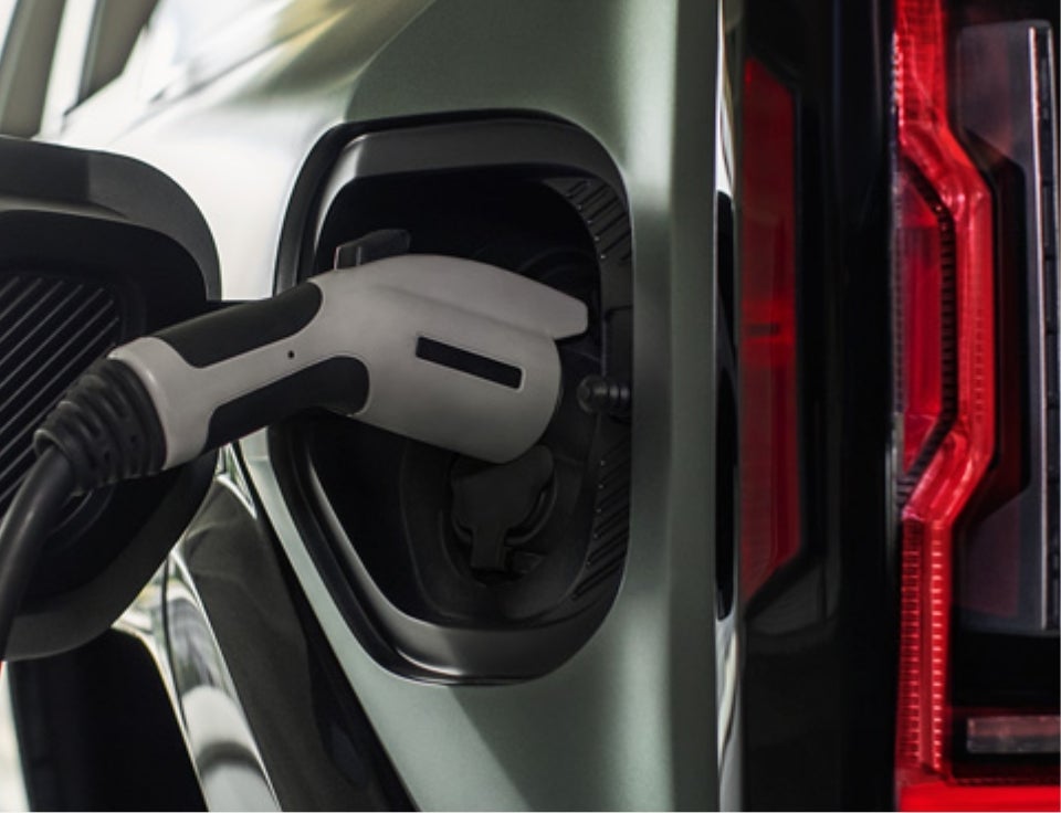 Close up of charging port with charger plugged in on a GMC Hummer EV SUV - Jim Wernig GMC in Gaylord MI